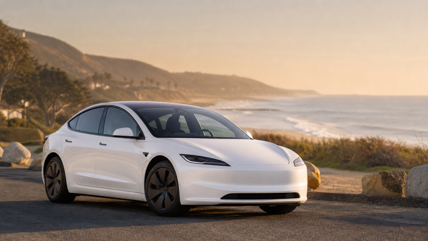 White compact electric sedan on a coastal road for the Tesla Model 3 guide